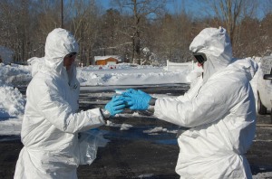 As part of the National Technical Nuclear Forensics Ground Collections Task Force, Staff Sgt. Caleb Cobb (left) and Sgt. Terry Sparkman, CBRNE Response Team members from the 68th Chemical Company, 22nd Chemical Battalion (Technical Escort), transfer a collection in Suffolk County, N.Y. Feb. 10.